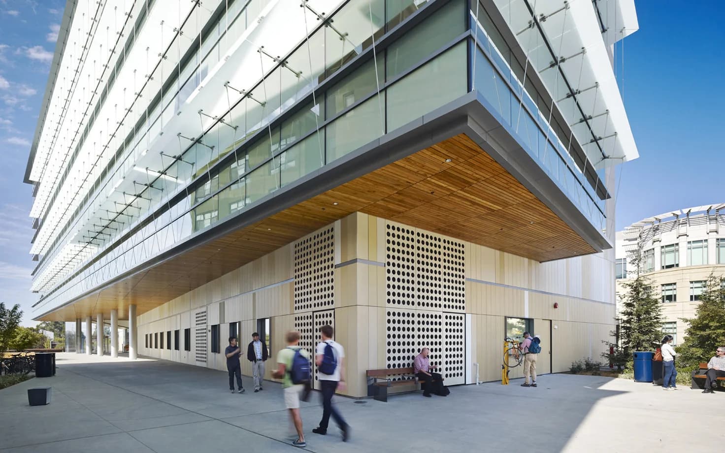 The IGI building’s glass facade and timber-lined cantilever above a public walkway at UC Berkeley