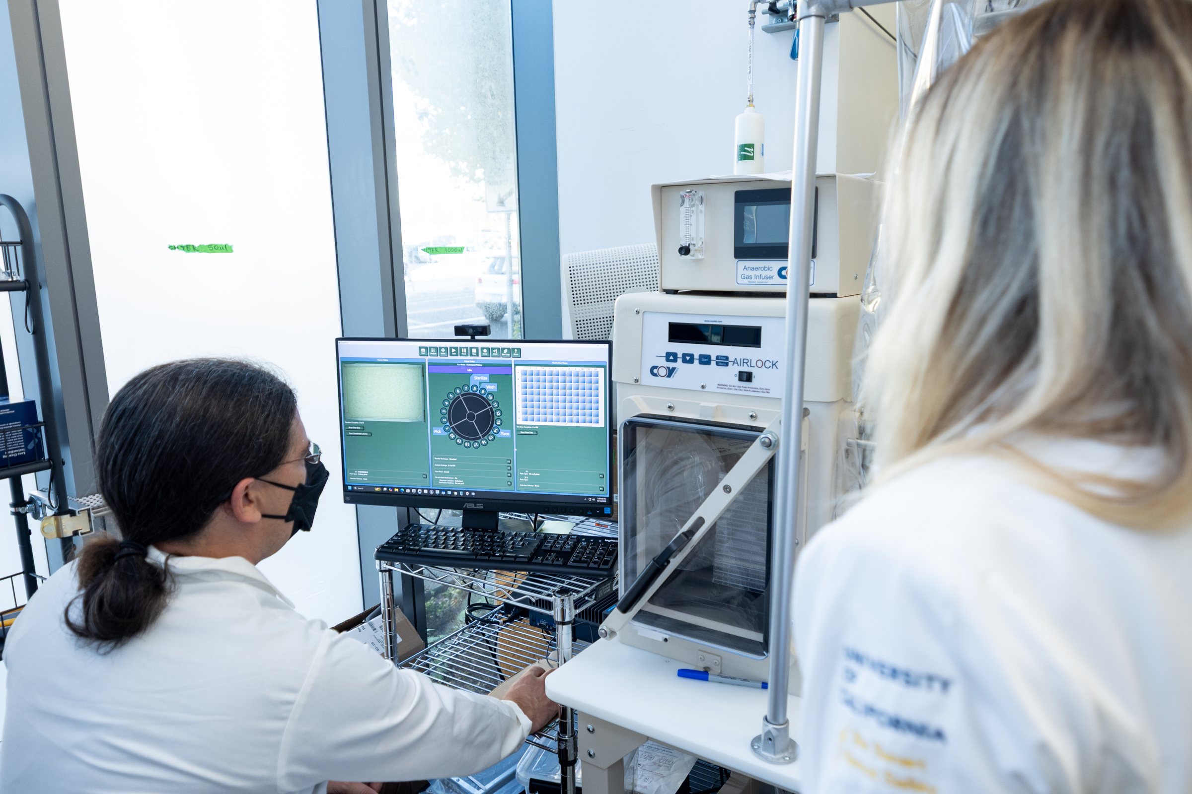 Lab members working at a chamber control workstation